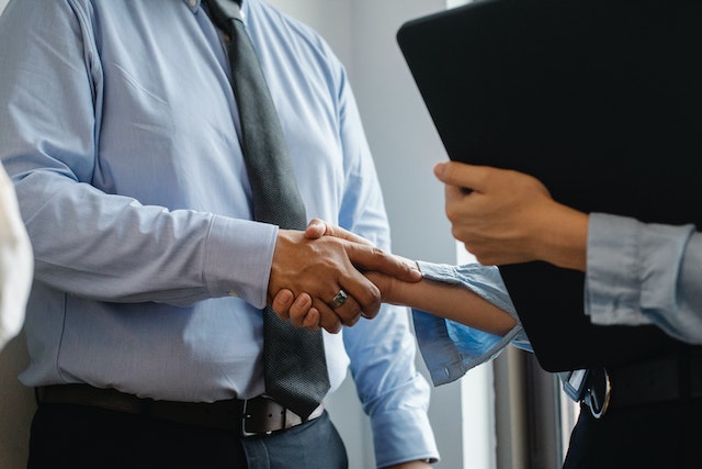 two people in suits shaking hands