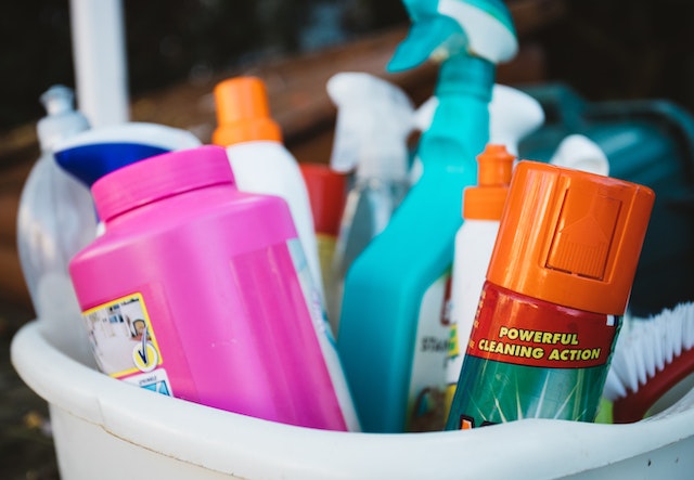 a bucket full of cleaning supplies